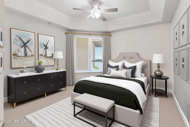 932 1st St N Unit 902, Jacksonville Beach, FL 32250 - bedroom with light colored carpet, a raised ceiling, baseboards, and a ceiling fan