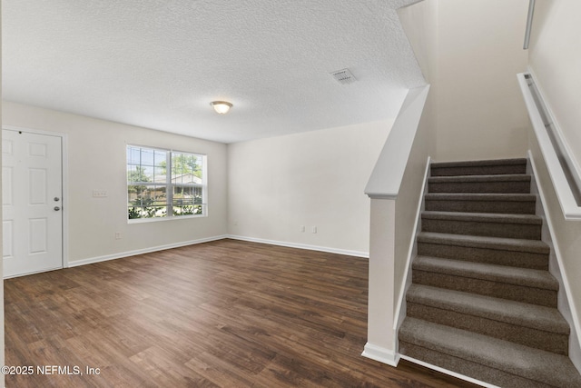 1343 Pangola Dr, Jacksonville, FL 32205 - staircase with wood finished floors and a textured ceiling