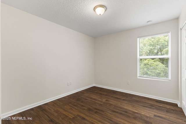 1343 Pangola Dr, Jacksonville, FL 32205 - spare room with dark wood-style flooring, a smoke detector, and a textured ceiling