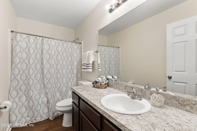 1343 Pangola Dr, Jacksonville, FL 32205 - bathroom with vanity, wood finished floors, a textured ceiling, and a shower with curtain