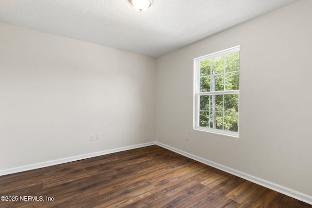 1343 Pangola Dr, Jacksonville, FL 32205 - unfurnished room with baseboards and dark wood-type flooring