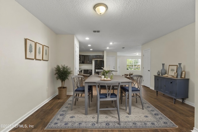 1343 Pangola Dr, Jacksonville, FL 32205 - dining area featuring dark wood-type flooring and a textured ceiling