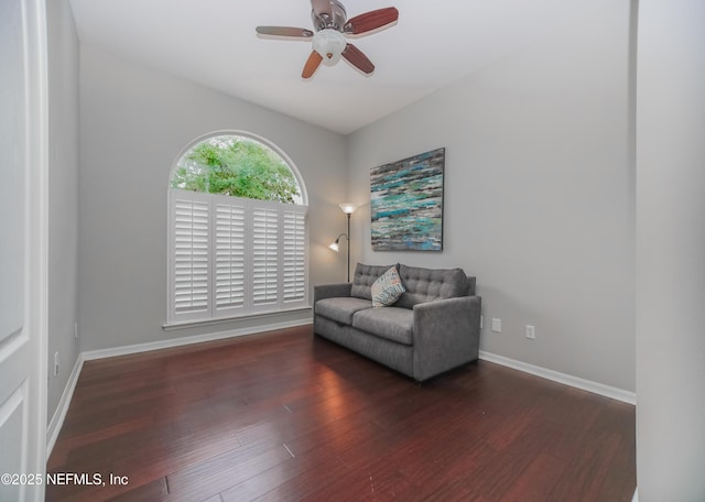 sitting room featuring wood finished floors, a ceiling fan, and baseboards
