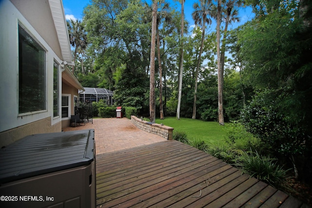 wooden deck featuring a patio area and a yard