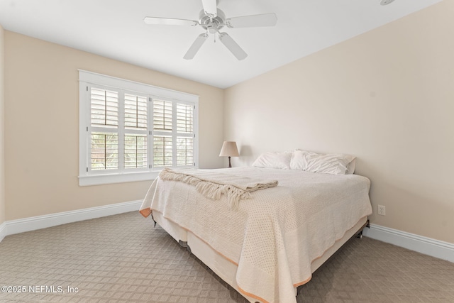 bedroom featuring baseboards, a ceiling fan, and carpet