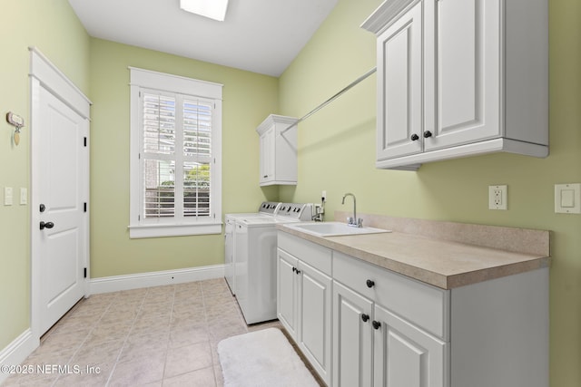 laundry room with cabinet space, washer and clothes dryer, and baseboards