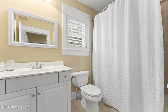 full bath featuring toilet, vanity, and tile patterned floors