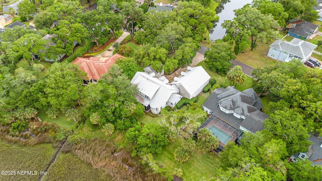 aerial view of residential area featuring a tree filled landscape