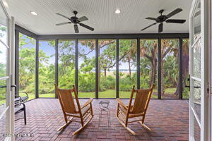 sunroom / solarium with ceiling fan, brick flooring, and recessed lighting
