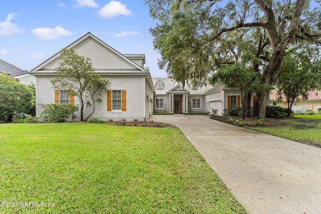 neoclassical / greek revival house featuring concrete driveway, a front lawn, an attached garage, and a standing seam roof