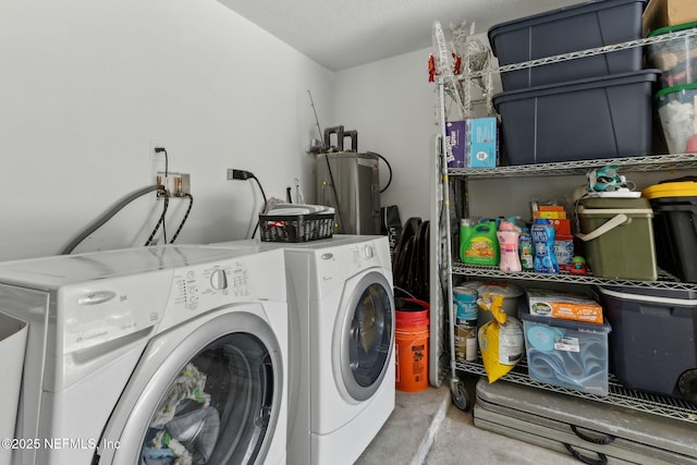 washroom with electric water heater and washer and clothes dryer