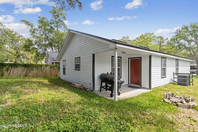 rear view of property with central AC and a patio