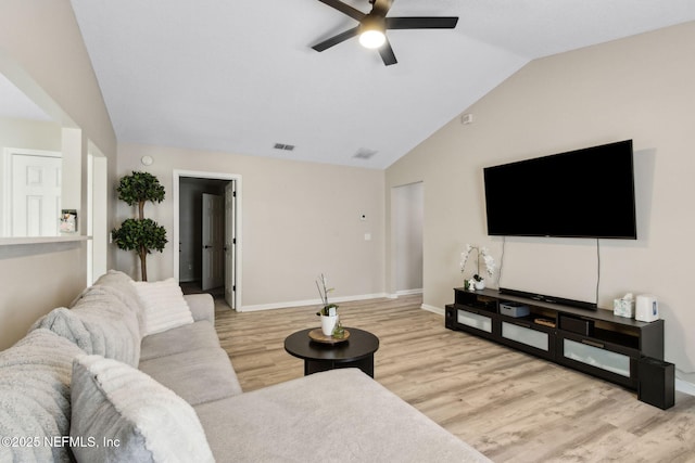 living room featuring lofted ceiling, a ceiling fan, wood finished floors, and baseboards