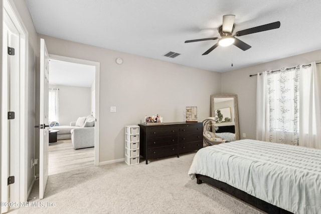 carpeted bedroom featuring ceiling fan and baseboards