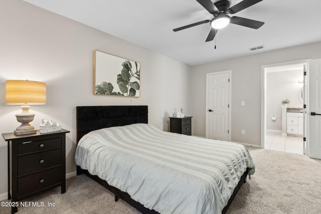 carpeted bedroom with baseboards and ensuite bathroom