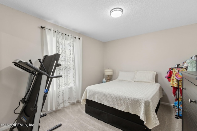 carpeted bedroom with baseboards and a textured ceiling