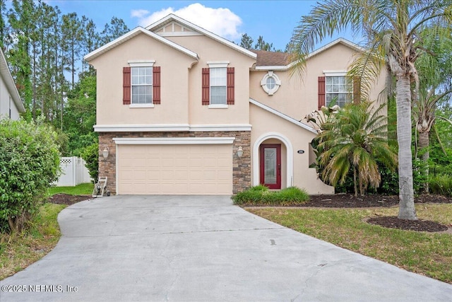 221 Thornloe Dr, Saint Johns, FL 32259 - view of front of home with stucco siding, driveway, a garage, fence, and stone siding