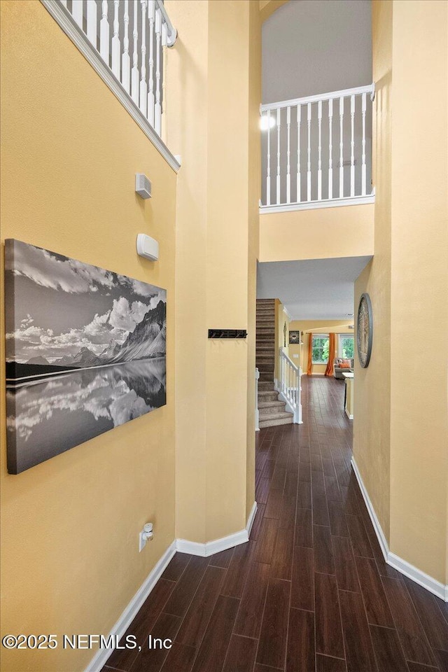 221 Thornloe Dr, Saint Johns, FL 32259 - corridor featuring baseboards, wood finished floors, a towering ceiling, and stairway