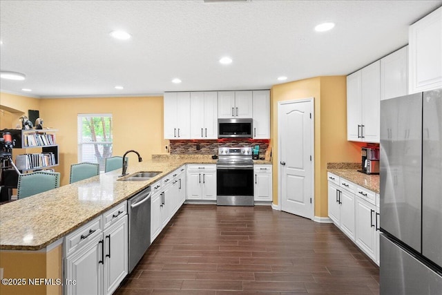 221 Thornloe Dr, Saint Johns, FL 32259 - kitchen featuring appliances with stainless steel finishes, a sink, a peninsula, white cabinetry, and recessed lighting