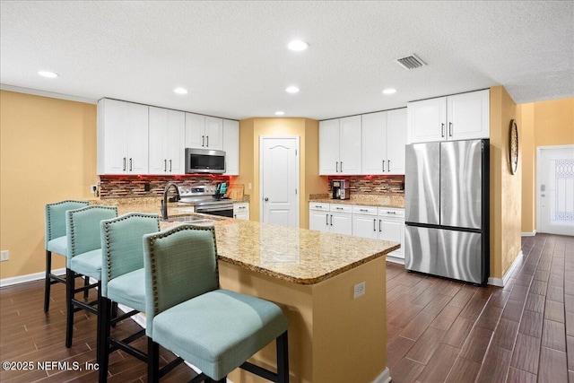 221 Thornloe Dr, Saint Johns, FL 32259 - kitchen with appliances with stainless steel finishes, dark wood-type flooring, baseboards, light stone countertops, and tasteful backsplash