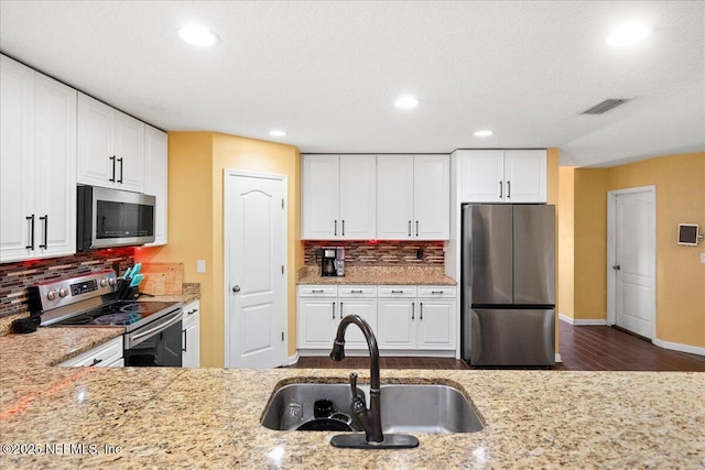 221 Thornloe Dr, Saint Johns, FL 32259 - kitchen featuring stainless steel appliances, a sink, tasteful backsplash, recessed lighting, and light stone counters