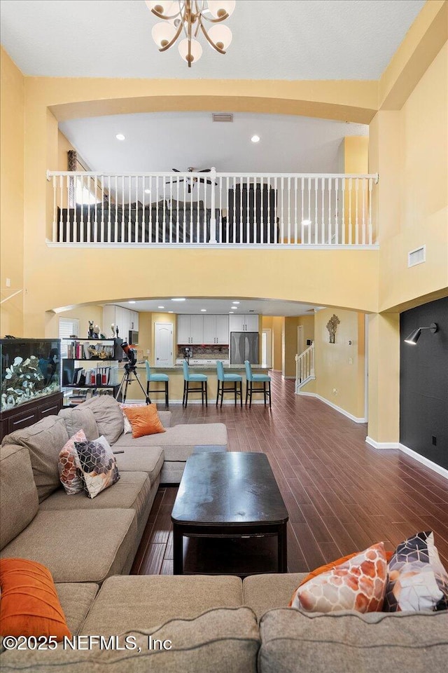 221 Thornloe Dr, Saint Johns, FL 32259 - living area with a high ceiling, wood finished floors, a chandelier, and baseboards