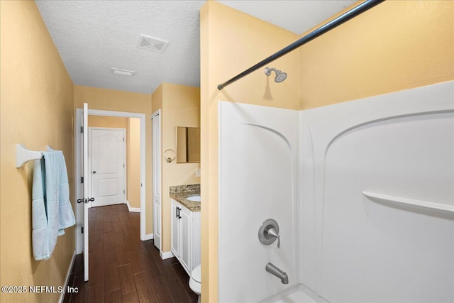 221 Thornloe Dr, Saint Johns, FL 32259 - bathroom with bathing tub / shower combination, wood finished floors, baseboards, vanity, and a textured ceiling