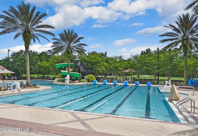221 Thornloe Dr, Saint Johns, FL 32259 - community pool featuring a water slide, view of wooded area, a patio, and fence