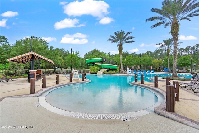 221 Thornloe Dr, Saint Johns, FL 32259 - community pool with a water slide, a patio area, and view of wooded area