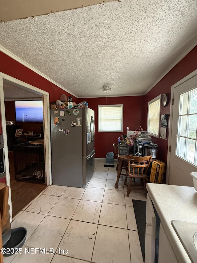 dining room with a textured ceiling and ornamental molding