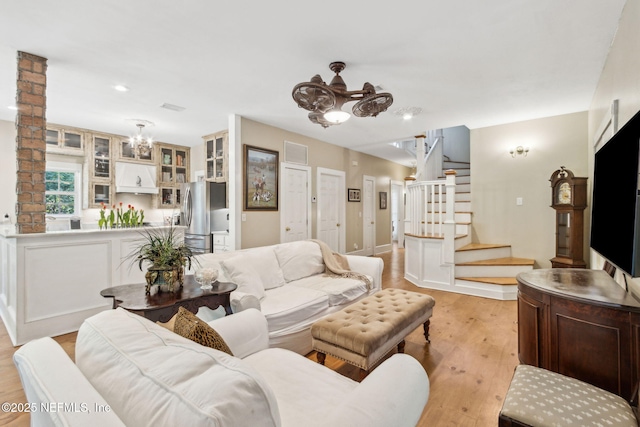 96448 Marsh Hen Rd, Fernandina Beach, FL 32034 - living area featuring a chandelier, stairway, light wood-style flooring, recessed lighting, and baseboards