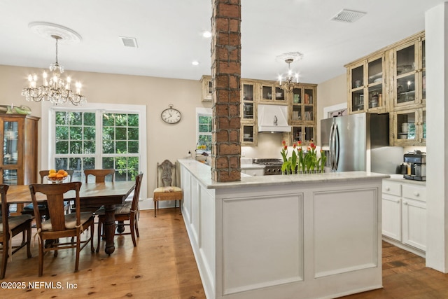 96448 Marsh Hen Rd, Fernandina Beach, FL 32034 - kitchen featuring a chandelier, premium range hood, light wood-style flooring, and light countertops