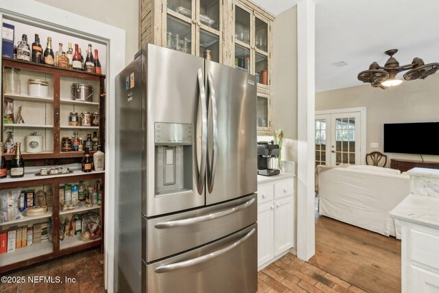 96448 Marsh Hen Rd, Fernandina Beach, FL 32034 - kitchen with stainless steel refrigerator with ice dispenser, french doors, glass insert cabinets, open floor plan, and light countertops