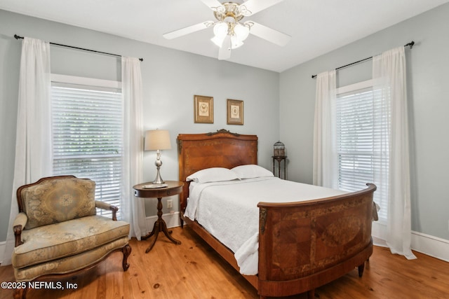 96448 Marsh Hen Rd, Fernandina Beach, FL 32034 - bedroom with wood finished floors, baseboards, and ceiling fan