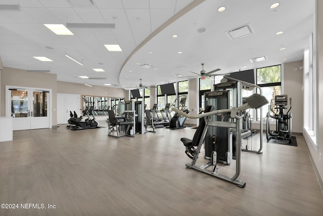 workout area featuring ceiling fan, wood finished floors, recessed lighting, and a paneled ceiling