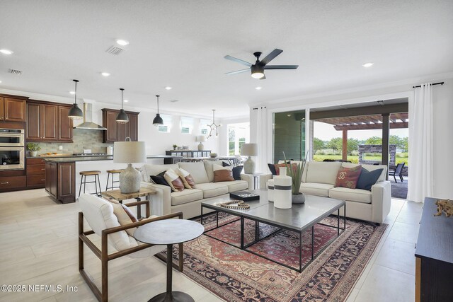 living area with ceiling fan and recessed lighting