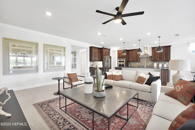 living area featuring ceiling fan, ornamental molding, recessed lighting, and baseboards