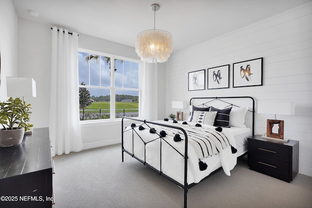 carpeted bedroom featuring a chandelier