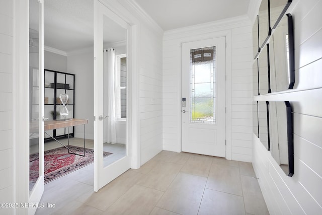 entrance foyer featuring crown molding and tile patterned flooring