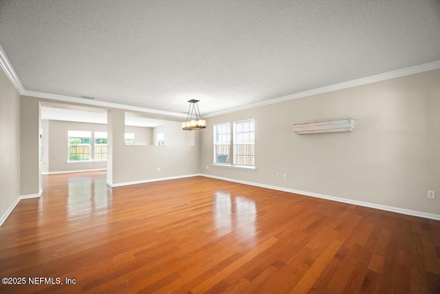 12198 Pebble Point Dr S, Jacksonville, FL 32218 - unfurnished room with a chandelier, ornamental molding, a textured ceiling, wood finished floors, and baseboards
