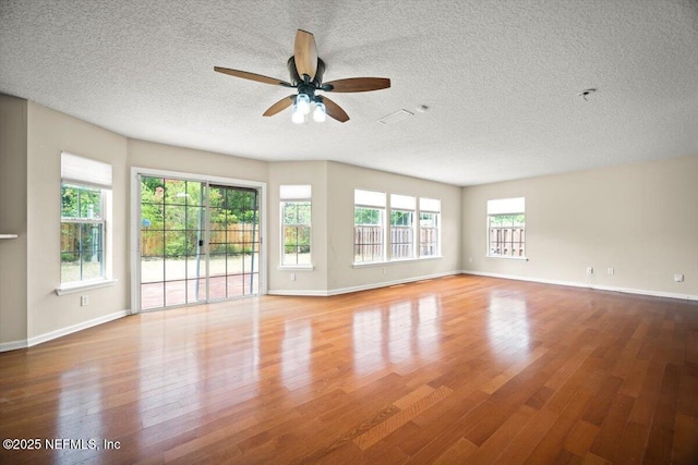 12198 Pebble Point Dr S, Jacksonville, FL 32218 - empty room with wood finished floors, a textured ceiling, ceiling fan, and baseboards
