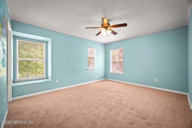 12198 Pebble Point Dr S, Jacksonville, FL 32218 - carpeted empty room with a ceiling fan, healthy amount of natural light, baseboards, and a textured ceiling