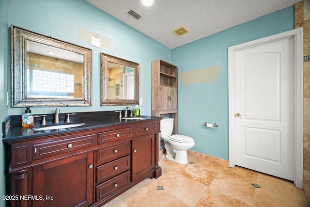 12198 Pebble Point Dr S, Jacksonville, FL 32218 - bathroom featuring toilet, double vanity, and a textured ceiling