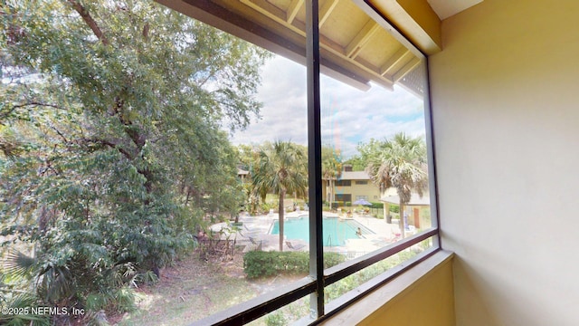balcony featuring view of pool area