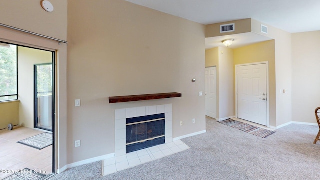 unfurnished living room featuring carpet, a fireplace, and baseboards