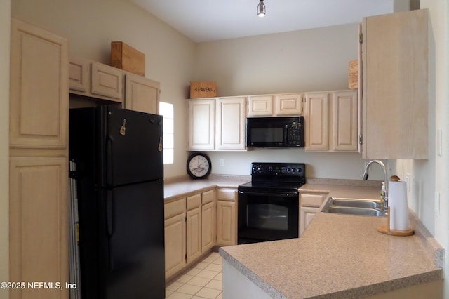 kitchen with black appliances, a sink, light countertops, light tile patterned floors, and a peninsula