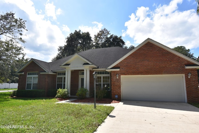 view of front of property featuring an attached garage, concrete driveway, brick siding, and a front lawn
