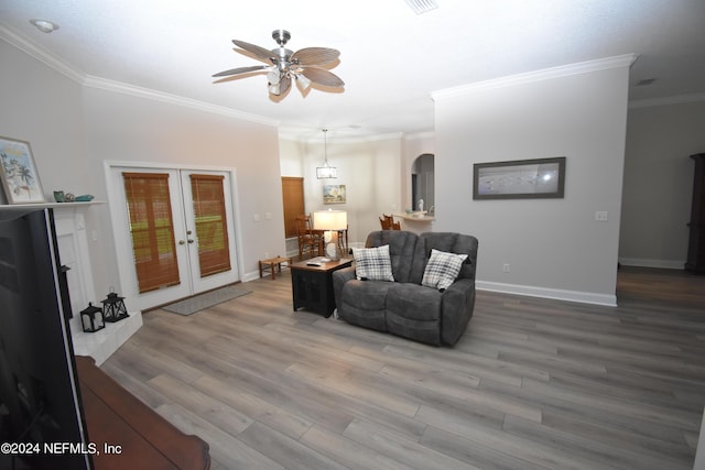 living room with ceiling fan, ornamental molding, wood finished floors, french doors, and baseboards