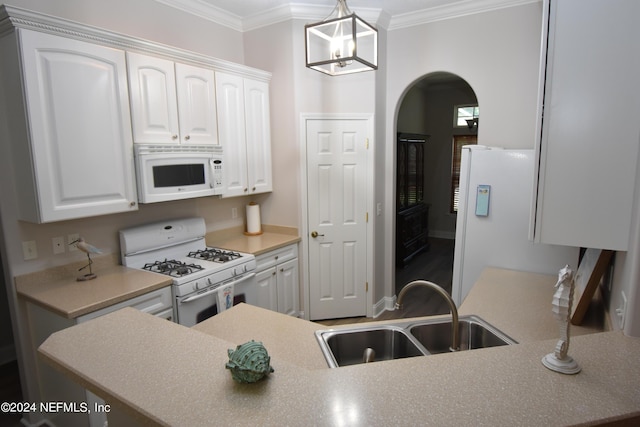 kitchen with white appliances, a sink, ornamental molding, arched walkways, and white cabinetry