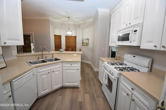 kitchen featuring white appliances, a sink, a peninsula, dark wood-type flooring, and white cabinets